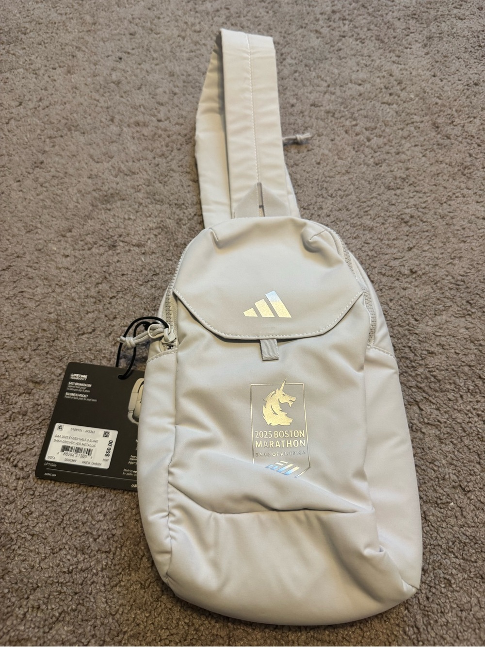 Adidas light gray sling belt bag with silver reflective logo